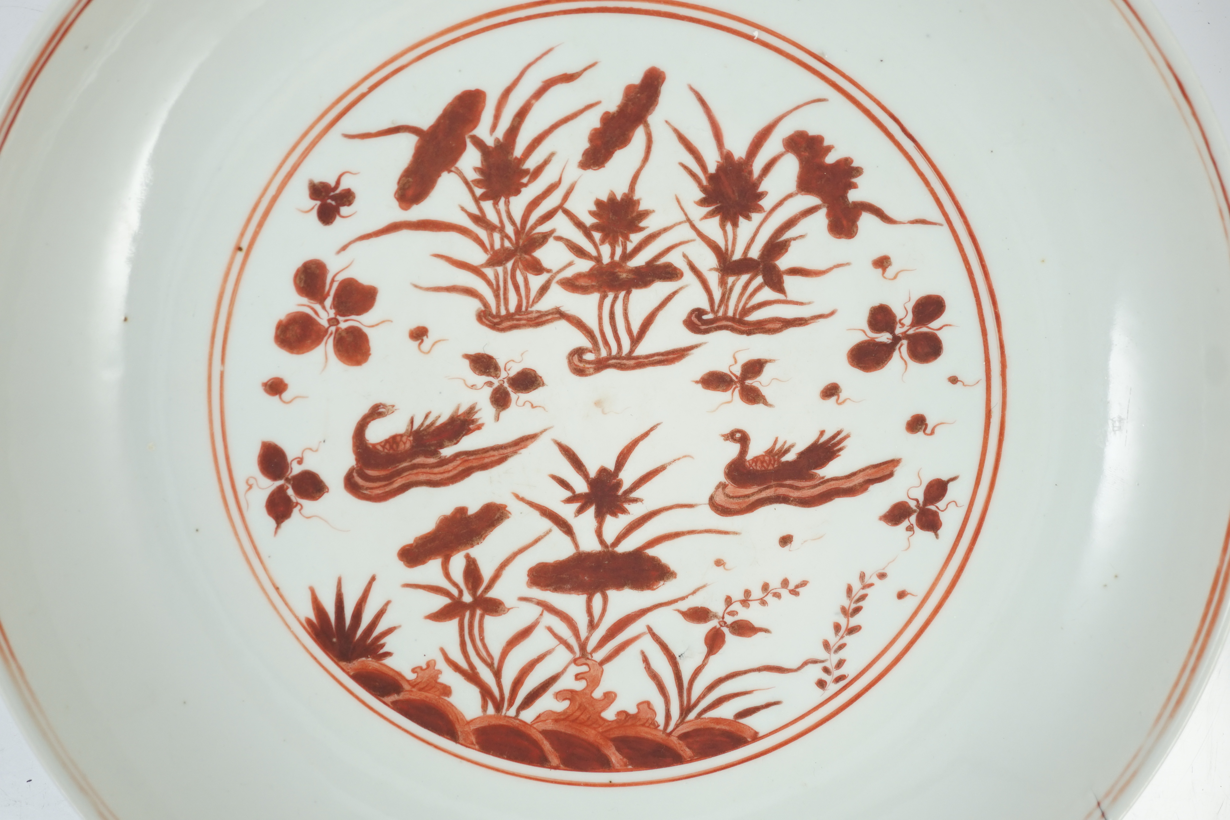 A large Chinese iron red enamelled ‘lotus pond’ dish, Wanli mark and possibly of the period